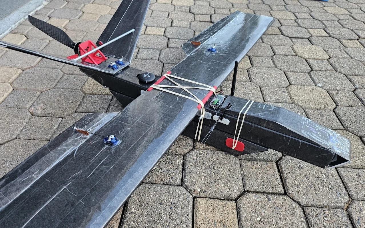 First foamboard survey aircraft with V-tail and custom landing gear outdoors