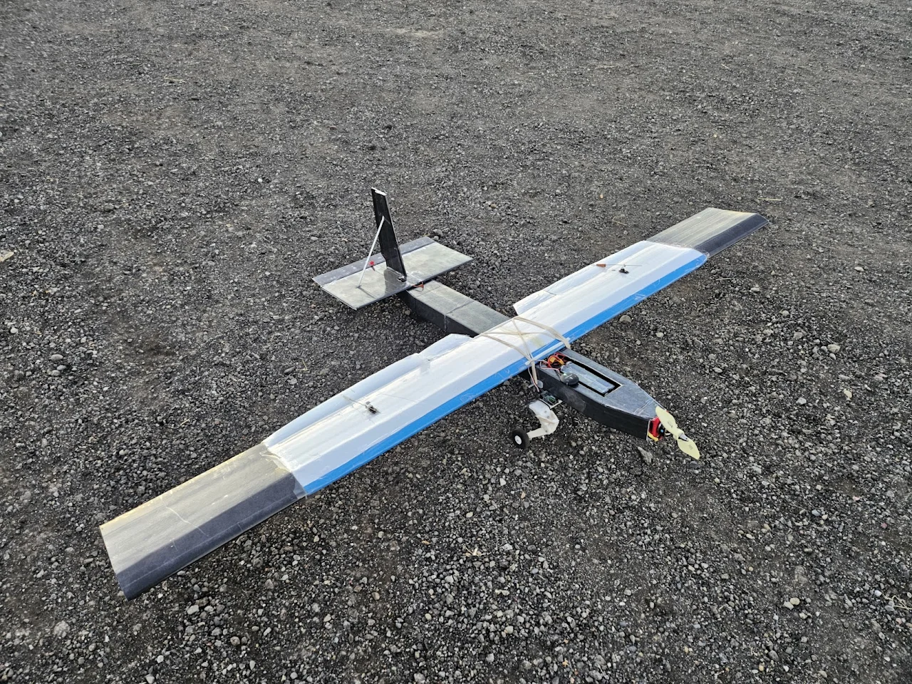 Second survey aircraft with conventional tail resting on gravel